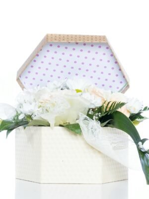 A beautifully arranged bouquet in a decorative gift box with polka dot lining, perfect for celebrations.