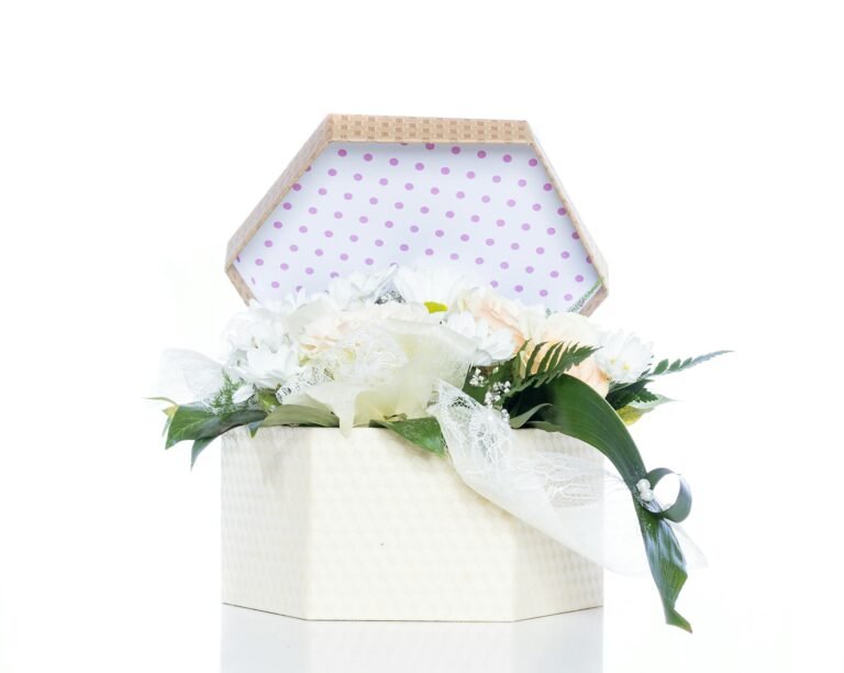 A beautifully arranged bouquet in a decorative gift box with polka dot lining, perfect for celebrations.