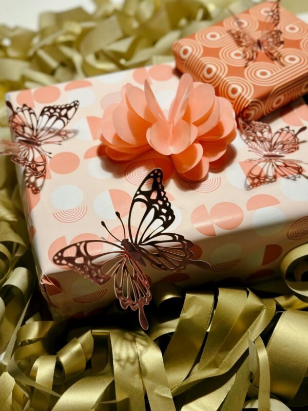 Beautifully wrapped gifts with butterfly decorations and floral accents.